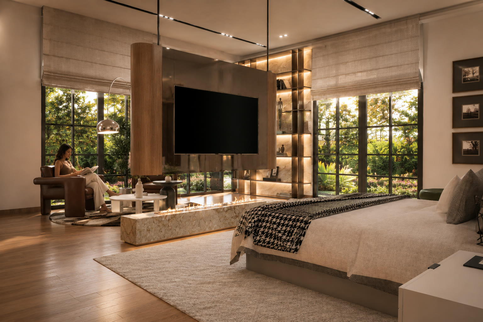 Across the bed to the screen side of the partition, with the fire below it, a reading chair beyond and garden windows on two sides under linen blinds